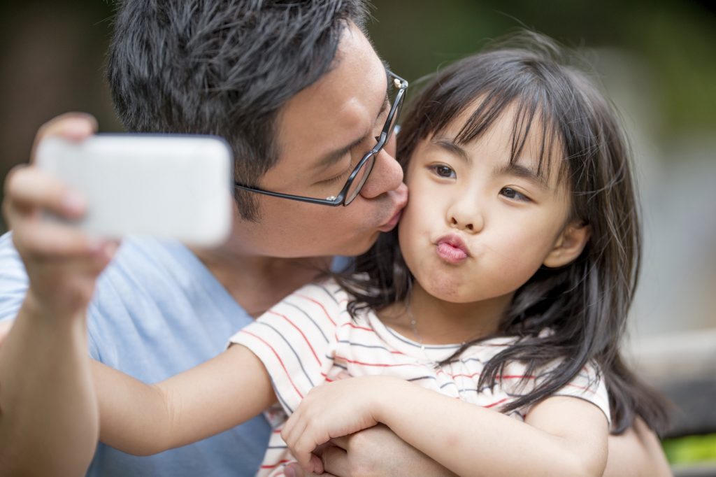 Father taking a selfie with a daughter