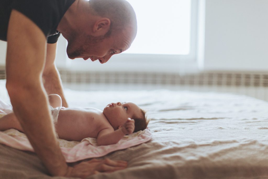 Portrait of a young father and his newborn baby